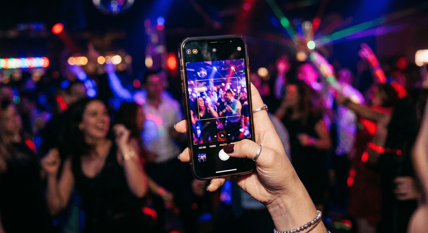Person taking a photo at a party with their phone